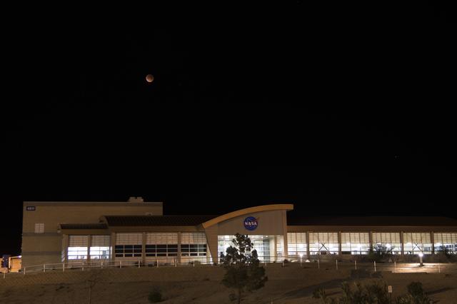 NASA image: Image shows January 31 Super Blue Blood Moon starting the lunar eclipse over NASA Armstrong Flight Research Center's mission support building located in California.