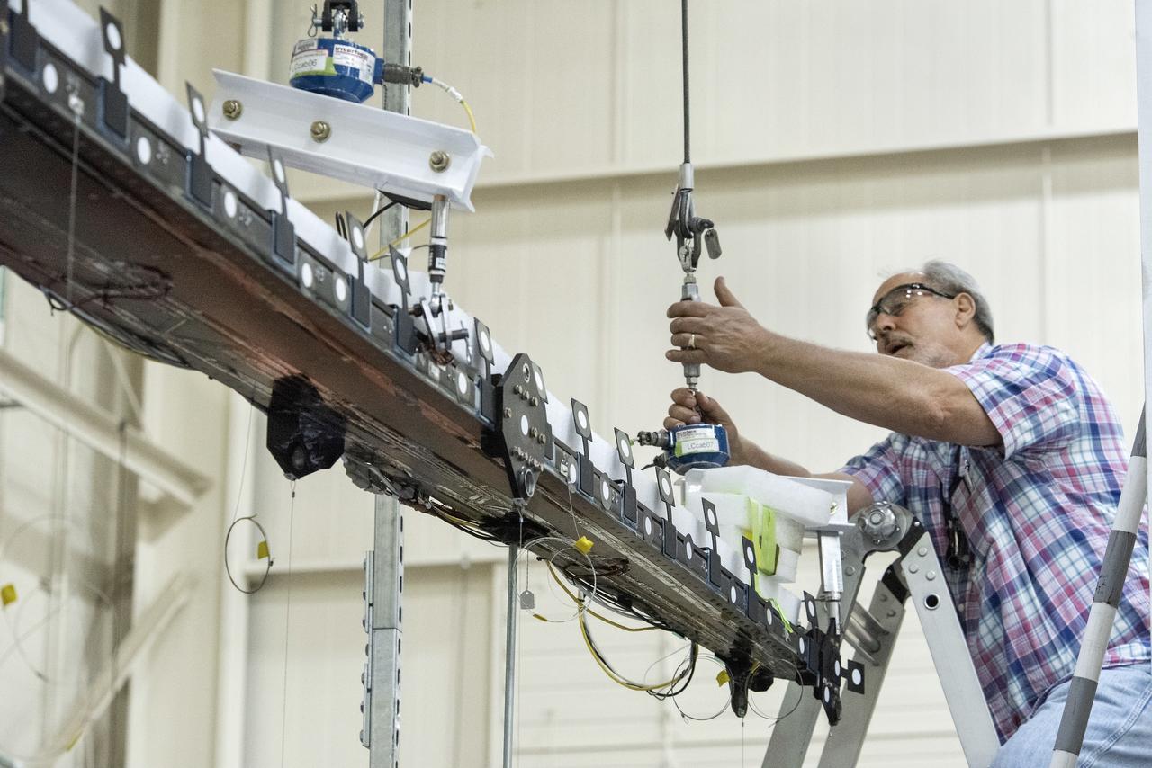 Ted Powers makes an adjustment to the Passive Aeroelastic Tailored (PAT) wing testing apparatus at NASA’s Armstrong Flight Research Center in California.