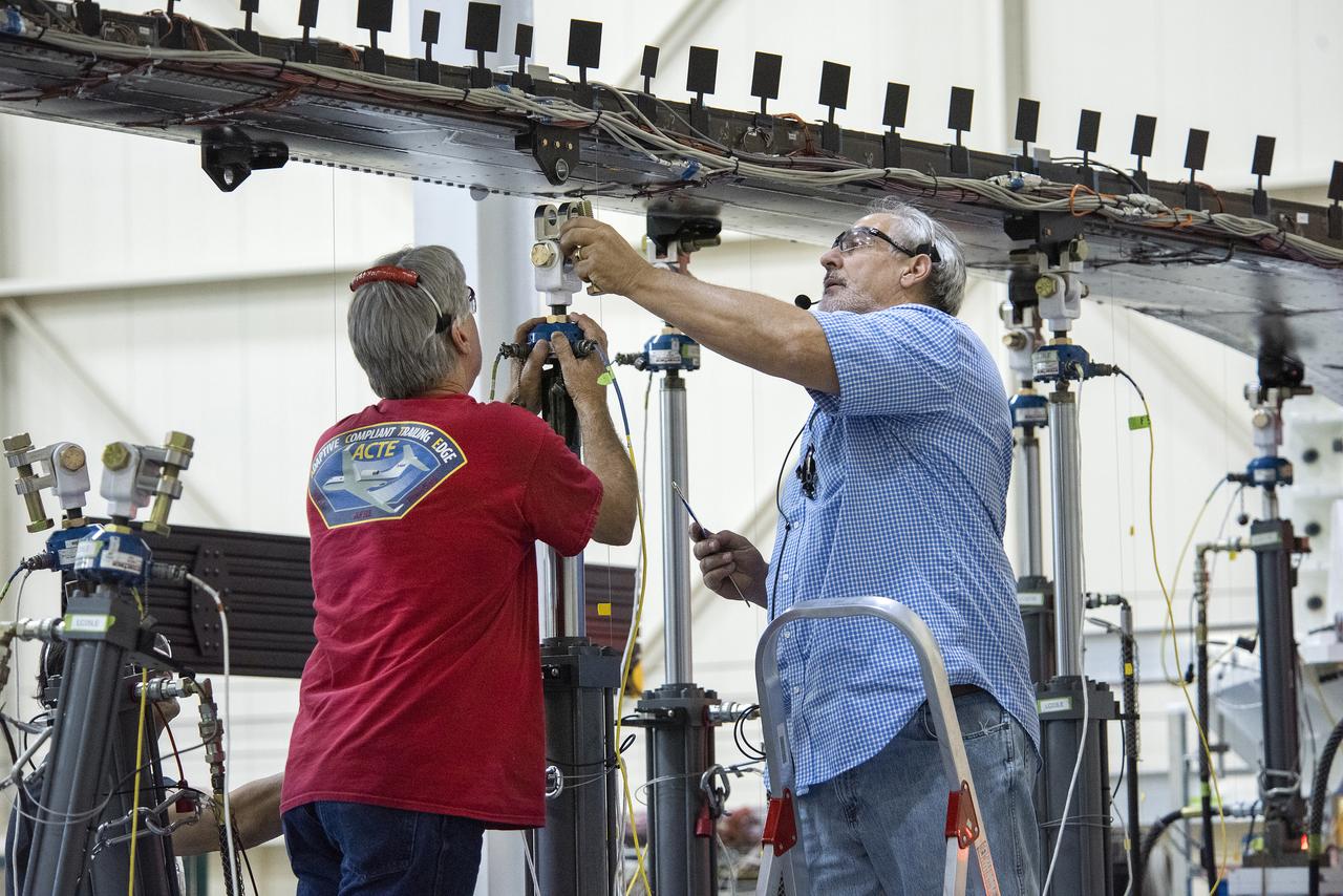 Wally Hargis, left, and Ted Powers complete preparations for testing the Passive Aeroelastic Tailored wing.