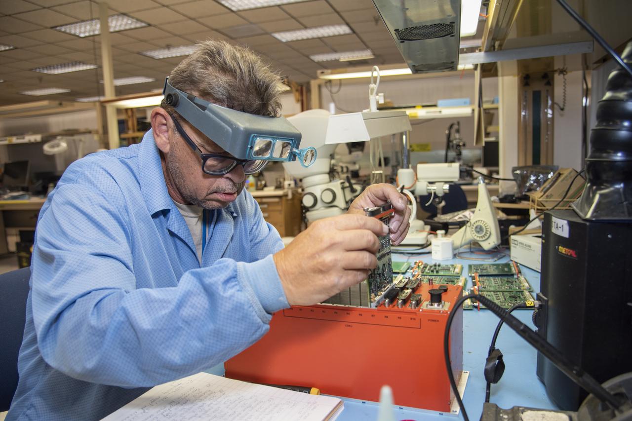 Randy Wagner prepares elements of the Orion Ascent Abort 2 crew module backup data acquisition system for thermal testing at NASA's Armstrong Flight Research Center in California.