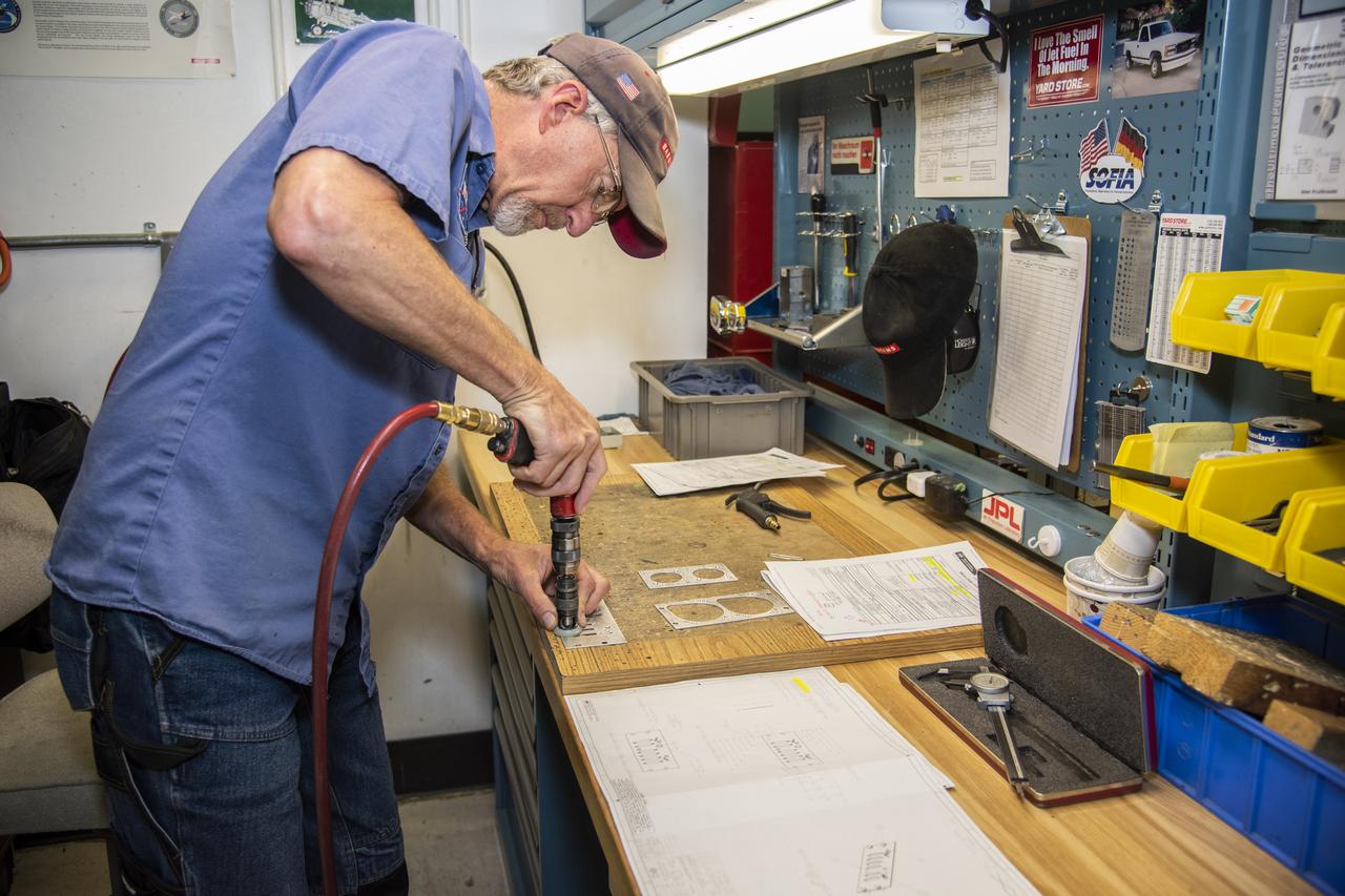 Andrew Shaw works on a component for the high-altitude ER-2 aircraft's instrument panel.
