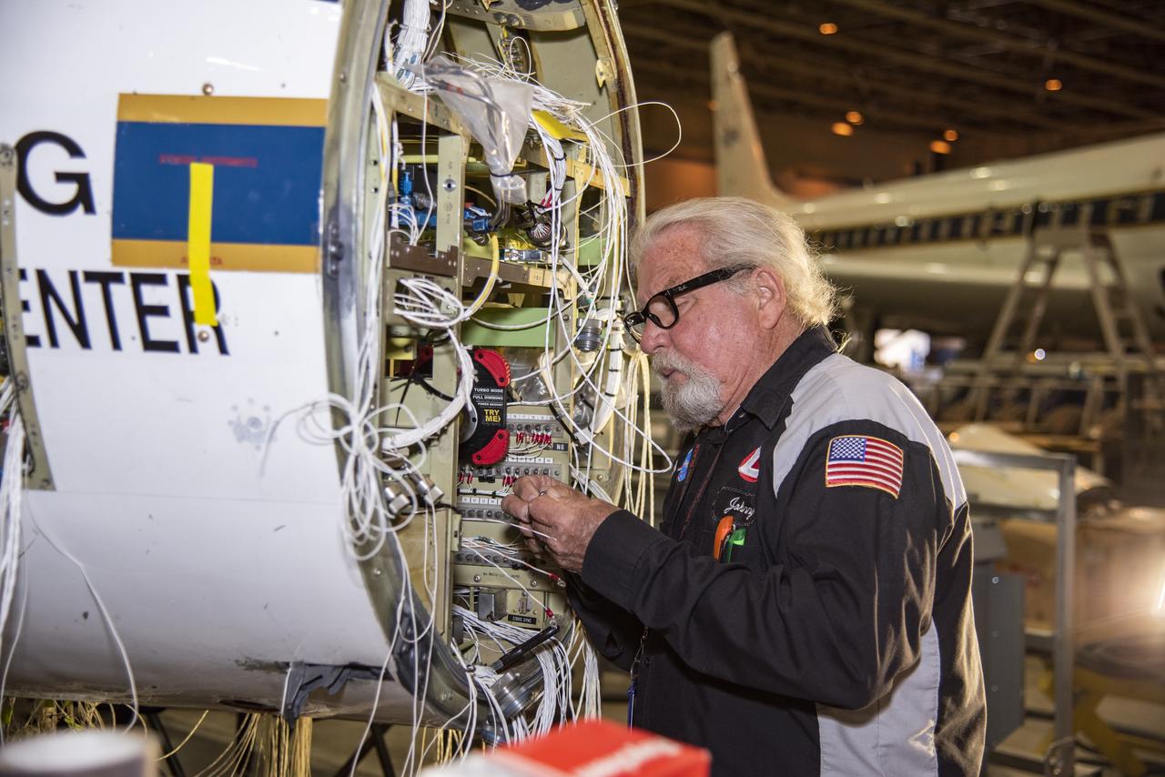 Technician Johnny Bryant works on rewiring the high-altitude aircraft's fixed nose and cockpit.