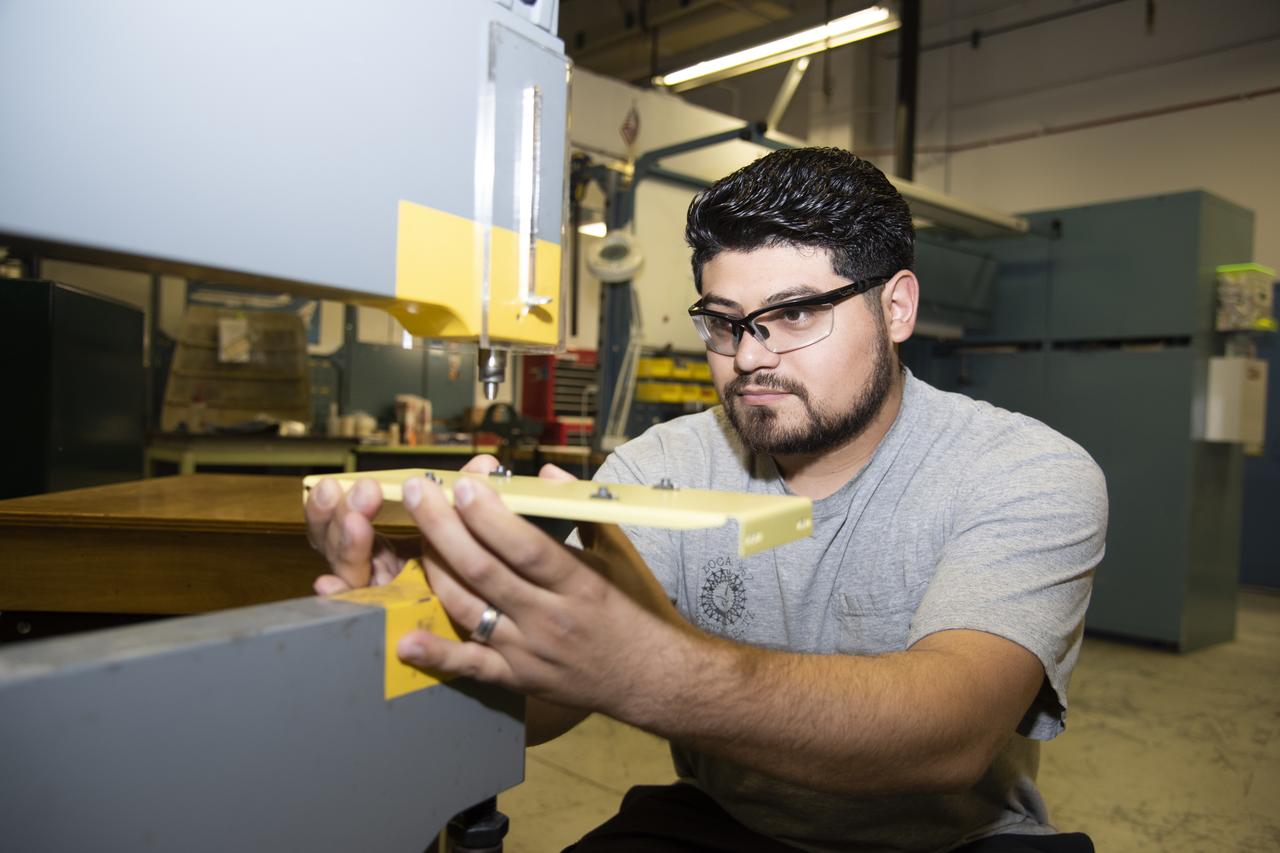 Hector Rosas works on fabricating a part for the ER-2 instrumentation panel.