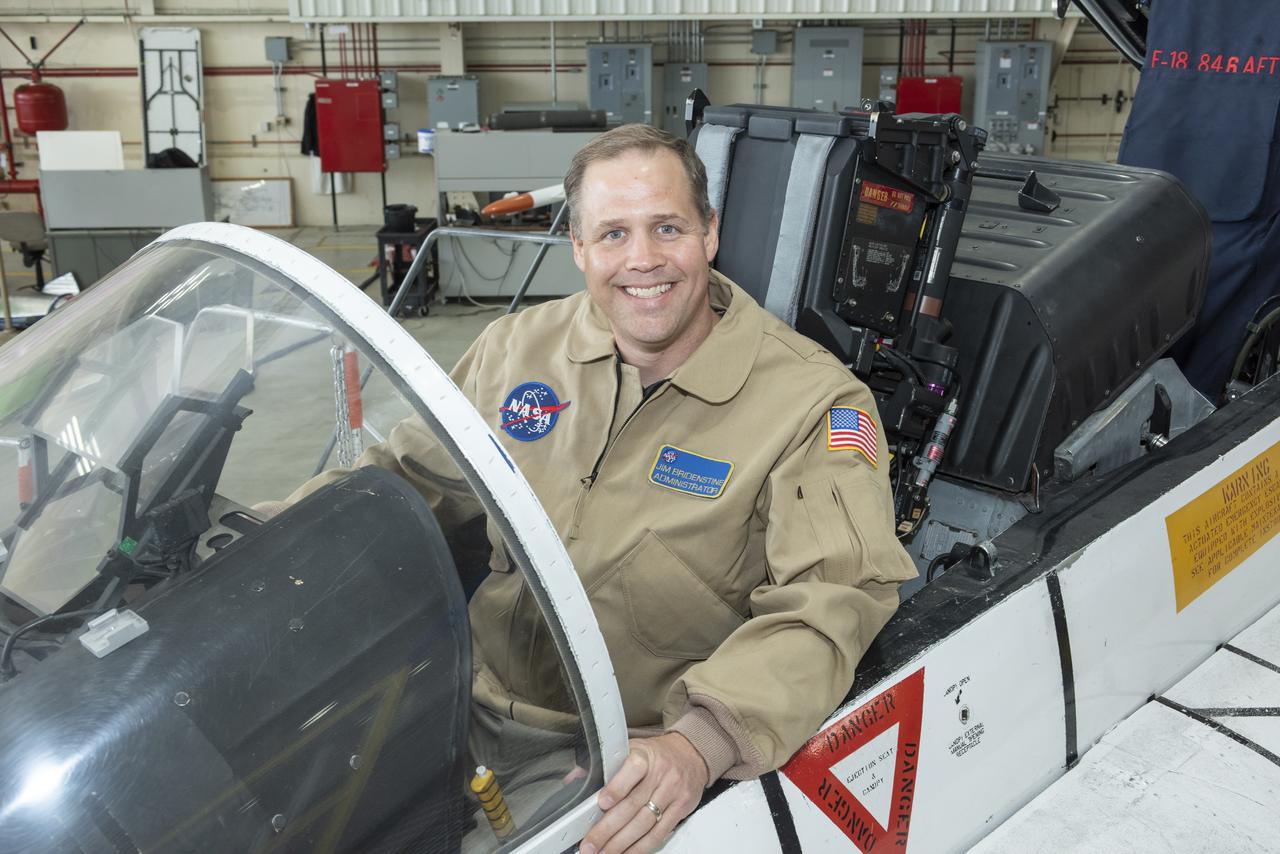 NASA Administrator Bridenstine, former navy pilot, sits comfortably back in F-18 jet cockpit at Armstrong Flight Research Center.
