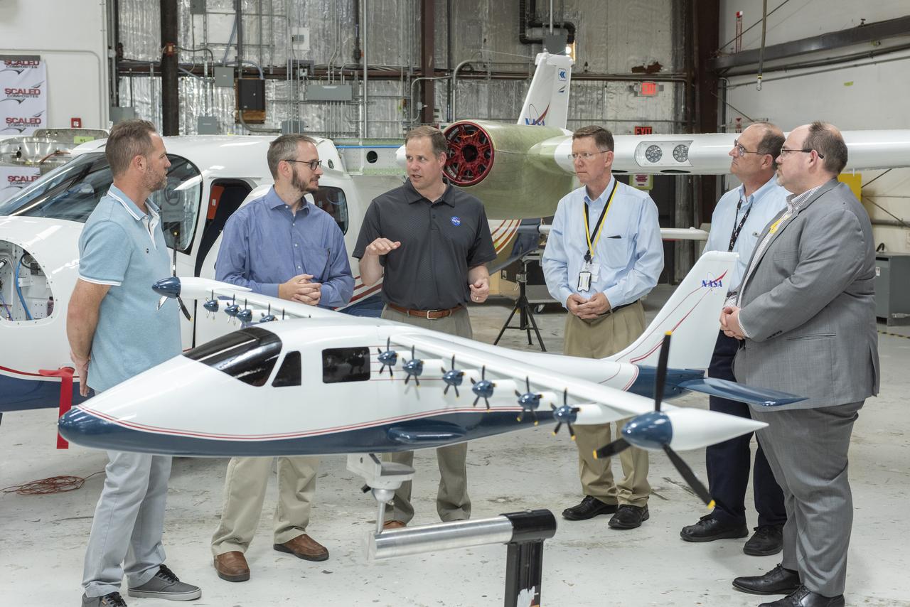 Administrator Bridenstine hears about the progress to modify the Tecnam P2006T from a combustion aircraft to an all-electric aircraft. Armstrong's X-57 team and ESAero, the prime contractor for the plane, are doing the briefing. The final configuration model of X-57 stands in front of group.