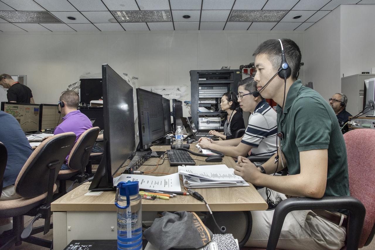 Alex Chin, Samson Truong and Mei Franz prepare for a flight of the remotely piloted X-56A