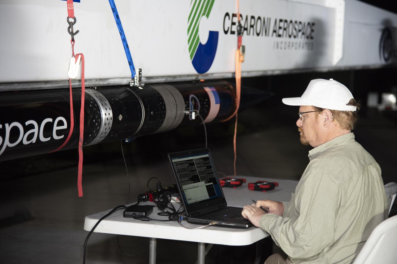 UP Aerospace employees preparing their SpaceLoft rocket to carry NASA technologies for testing in microgravity.