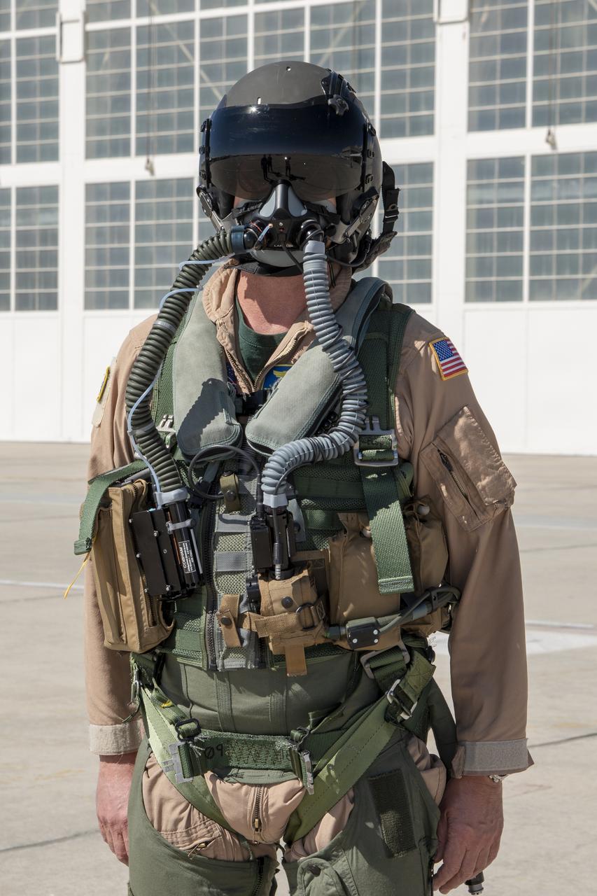 NASA Pilot Nils Larson wears a U.S. Navy harness configuration to show the integrated parachute harness and the built-in survival vest. The Navy configuration is bulkier and weighs more than the U.S. Air Force harness. Both configurations are being used in the Pilot Breathing Assessment program at NASA’s Armstrong Flight Research Center in California.