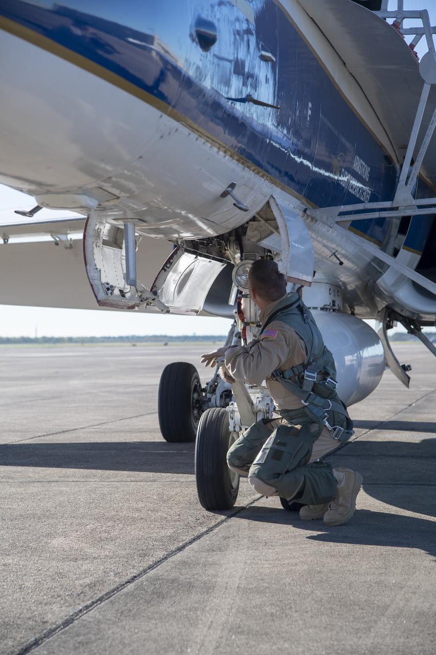 NASA test pilots Jim "Clue"Less and Wayne "Ringo" Ringelberg step to the F/A-18 research aircraft at Ellington Field and conduct pre-flight safety checks on the aircraft prior to a supersonic research flight for the QSF18 series.