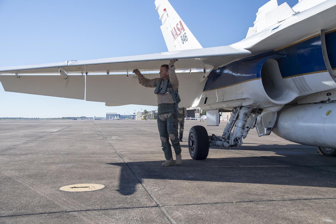 NASA test pilots Jim "Clue" Less and Wayne "Ringo" Ringelberg step to the F/A-18 research aircraft at Ellington Field and conduct pre-flight safety checks on the aircraft prior to a supersonic research flight for the QSF18 series.