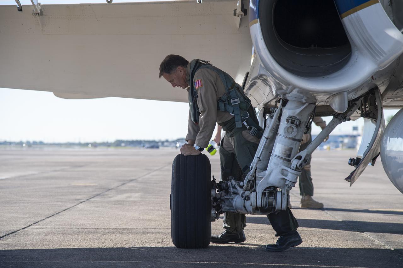 NASA test pilots Jim "Clue" Less and Wayne "Ringo" Ringelberg step to the F/A-18 research aircraft at Ellington Field and conduct pre-flight safety checks on the aircraft prior to a supersonic research flight for the QSF18 series.