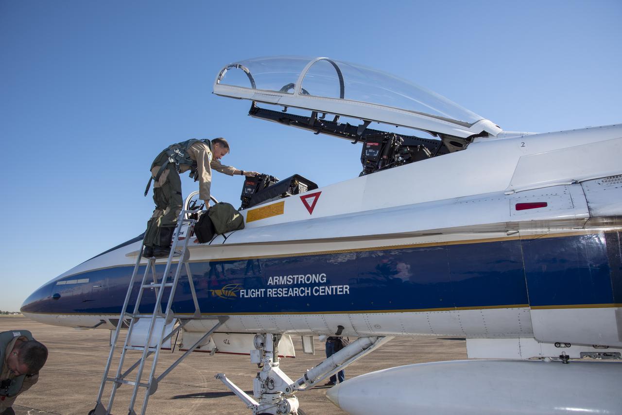 NASA test pilots Jim “Clue” Less and Wayne “Ringo” Ringelberg step to the F/A-18 research aircraft at Ellington Field and conduct pre-flight safety checks on the aircraft prior to a supersonic research flight for the QSF18 series.