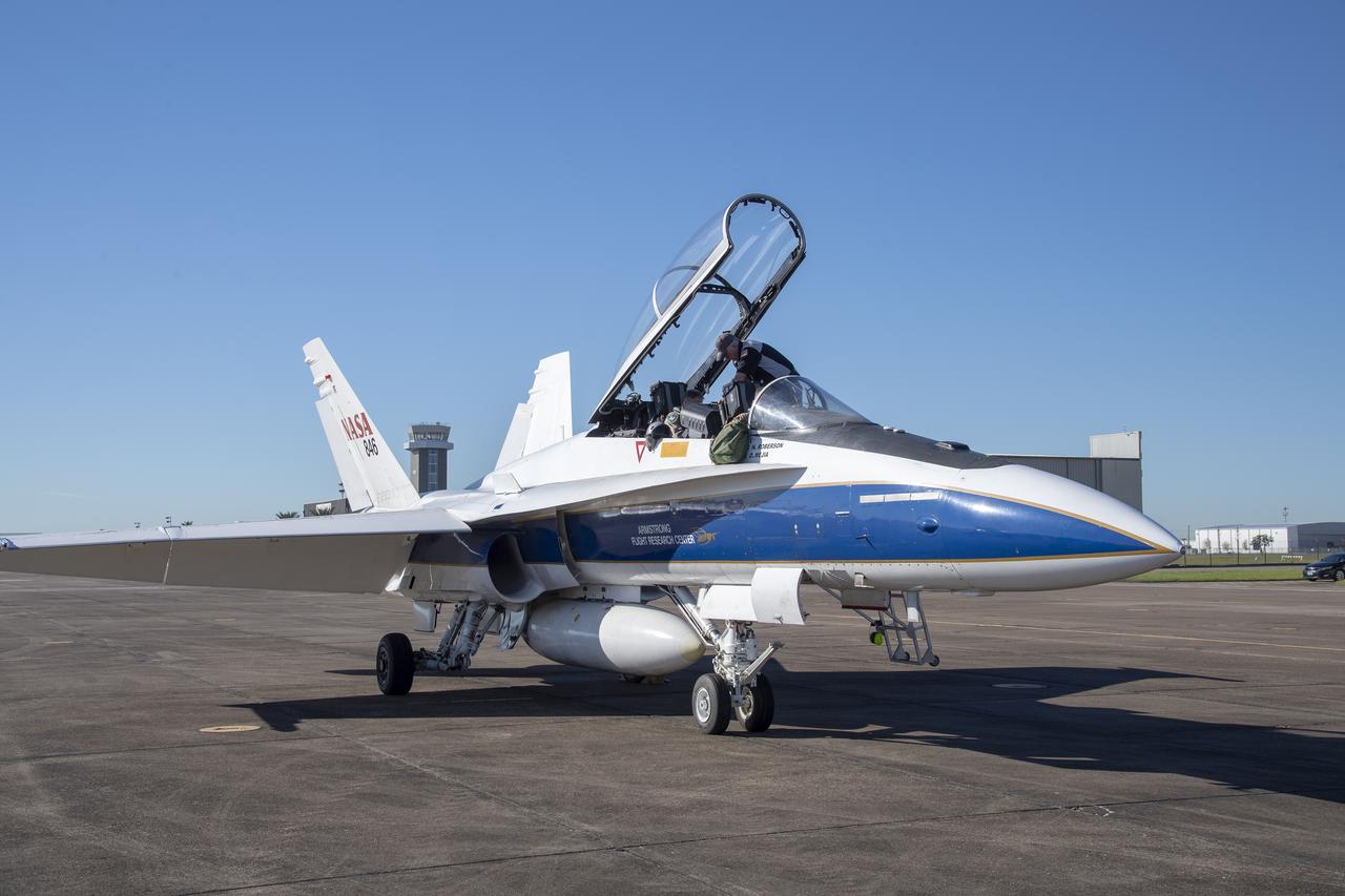NASA test pilots Jim “Clue” Less and Wayne “Ringo” Ringelberg step to the F/A-18 research aircraft at Ellington Field and conduct pre-flight safety checks on the aircraft prior to a supersonic research flight for the QSF18 series.