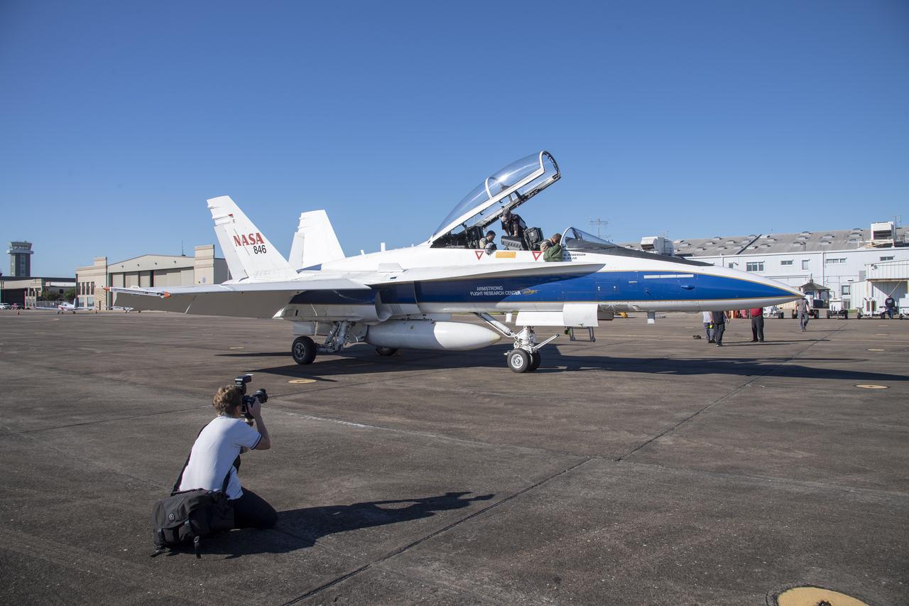 NASA test pilots Jim "Clue" Less and Wayne "Ringo"Ringelberg step to the F/A-18 research aircraft at Ellington Field and conduct pre-flight safety checks on the aircraft prior to a supersonic research flight for the QSF18 series.