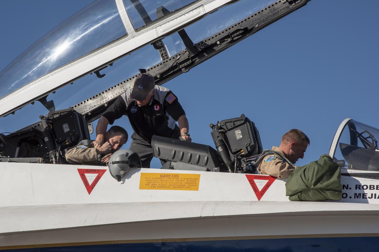 NASA test pilots Jim â€œClueâ€ Less and Wayne â€œRingoâ€ Ringelberg step to the F/A-18 research aircraft at Ellington Field and conduct pre-flight safety checks on the aircraft prior to a supersonic research flight for the QSF18 series.