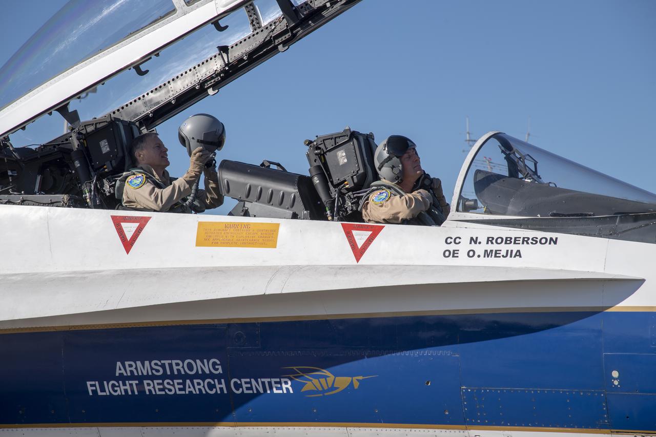 NASA test pilots Jim "Clue" Less and Wayne "Ringo" Ringelberg step to the F/A-18 research aircraft at Ellington Field and conduct pre-flight safety checks on the aircraft prior to a supersonic research flight for the QSF18 series.