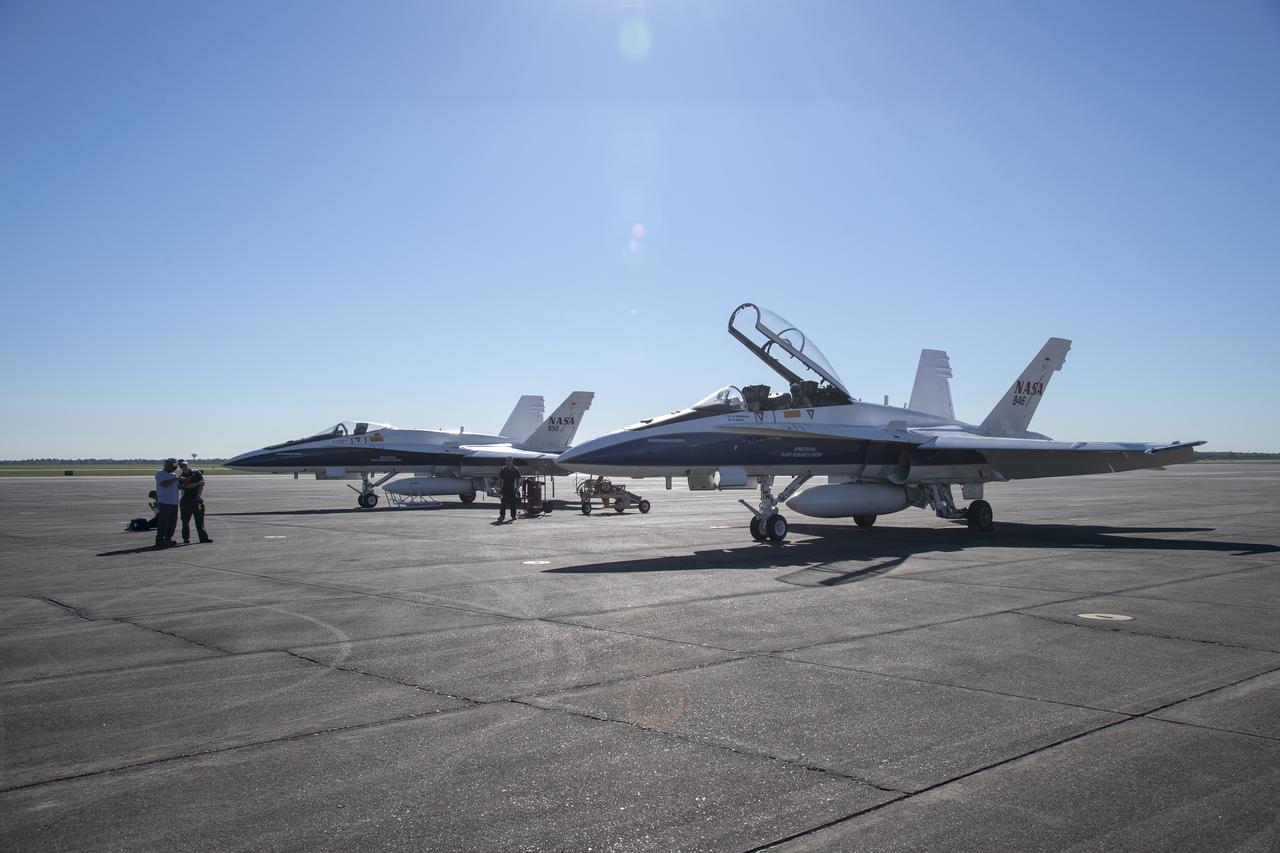 NASA test pilots Jim "Clue" Less and Wayne "Ringo" Ringelberg step to the F/A-18 research aircraft at Ellington Field and conduct pre-flight safety checks on the aircraft prior to a supersonic research flight for the QSF18 series.