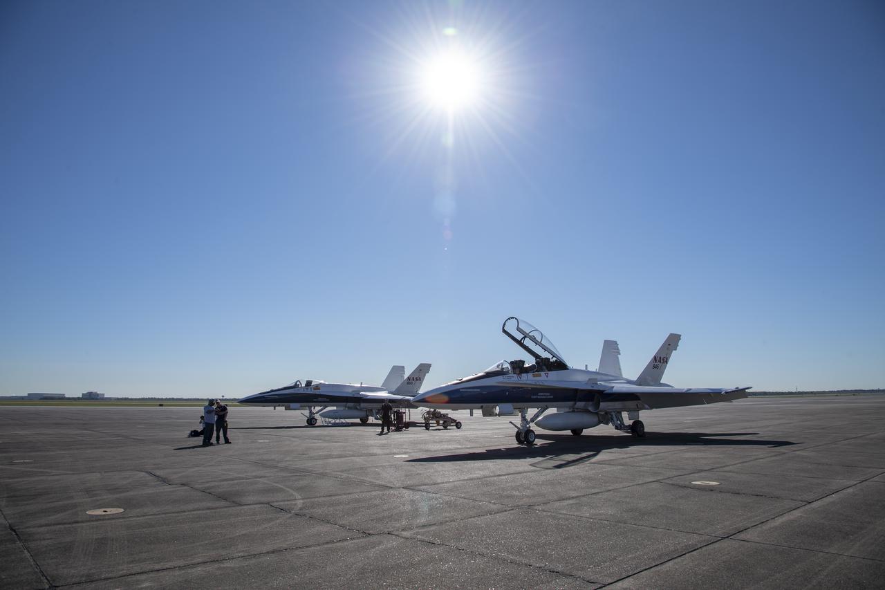 NASA test pilots Jim “Clue” Less and Wayne “Ringo” Ringelberg step to the F/A-18 research aircraft at Ellington Field and conduct pre-flight safety checks on the aircraft prior to a supersonic research flight for the QSF18 series.