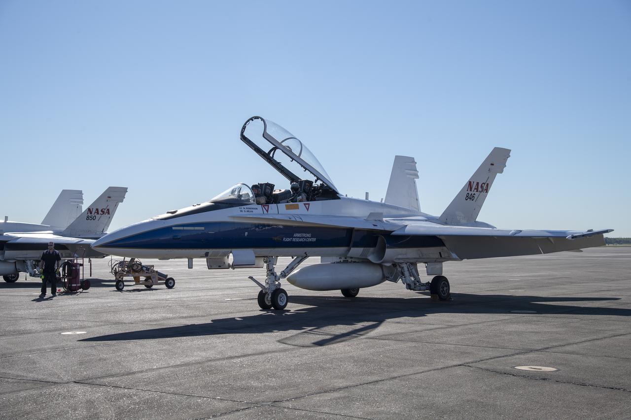 NASA test pilots Jim "Clue" Less and Wayne "Ringo" Ringelberg step to the F/A-18 research aircraft at Ellington Field and conduct pre-flight safety checks on the aircraft prior to a supersonic research flight for the QSF18 series.