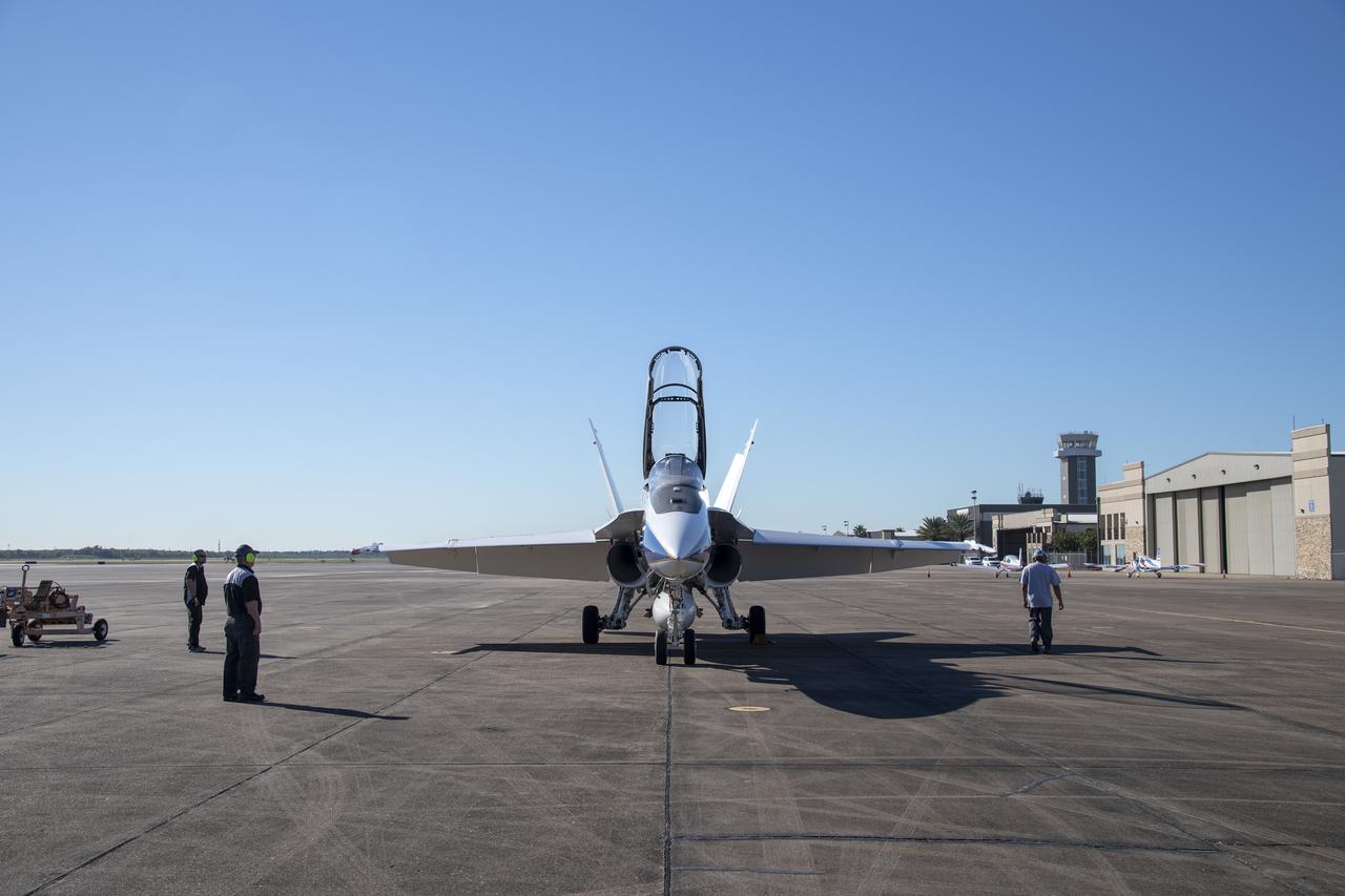 NASA test pilots Jim "Clue" Less and Wayne "Ringo" Ringelberg step to the F/A-18 research aircraft at Ellington Field and conduct pre-flight safety checks on the aircraft prior to a supersonic research flight for the QSF18 series.