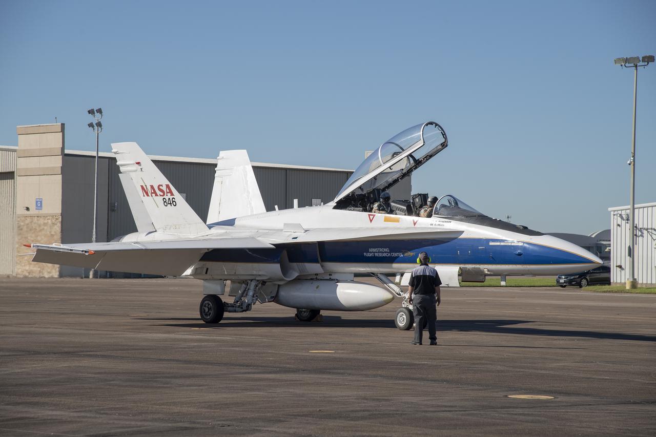 NASA test pilots Jim “Clue” Less and Wayne “Ringo” Ringelberg step to the F/A-18 research aircraft at Ellington Field and conduct pre-flight safety checks on the aircraft prior to a supersonic research flight for the QSF18 series.