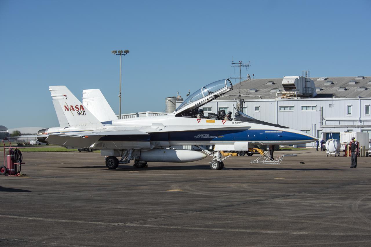 NASA test pilots Jim “Clue” Less and Wayne “Ringo” Ringelberg step to the F/A-18 research aircraft at Ellington Field and conduct pre-flight safety checks on the aircraft prior to a supersonic research flight for the QSF18 series.