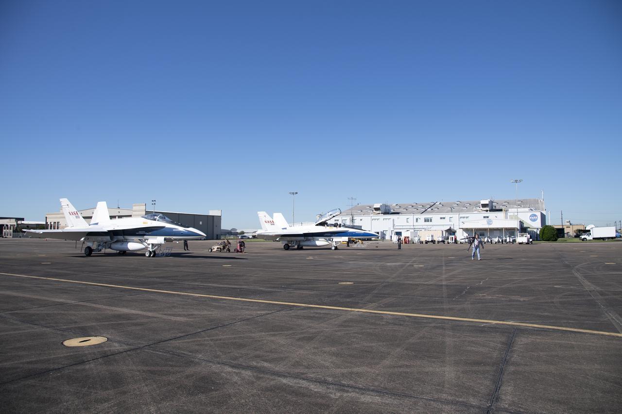 NASA test pilots Jim "Clue" Less and Wayne "Ringo" Ringelberg step to the F/A-18 research aircraft at Ellington Field and conduct pre-flight safety checks on the aircraft prior to a supersonic research flight for the QSF18 series.