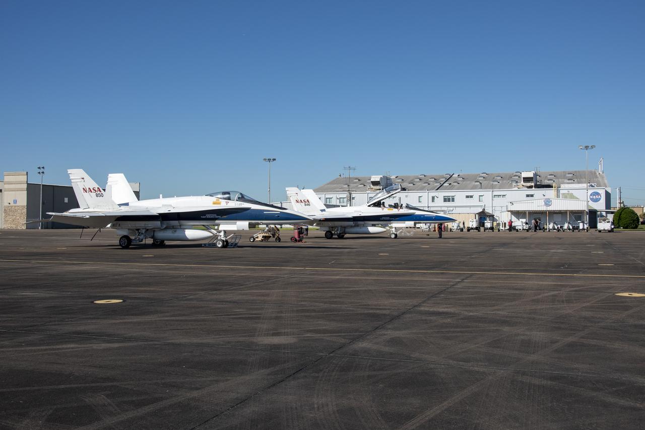 NASA test pilots Jim “Clue” Less and Wayne “Ringo” Ringelberg step to the F/A-18 research aircraft at Ellington Field and conduct pre-flight safety checks on the aircraft prior to a supersonic research flight for the QSF18 series.