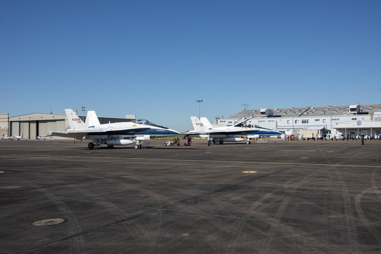 NASA test pilots Jim “Clue” Less and Wayne “Ringo” Ringelberg step to the F/A-18 research aircraft at Ellington Field and conduct pre-flight safety checks on the aircraft prior to a supersonic research flight for the QSF18 series.