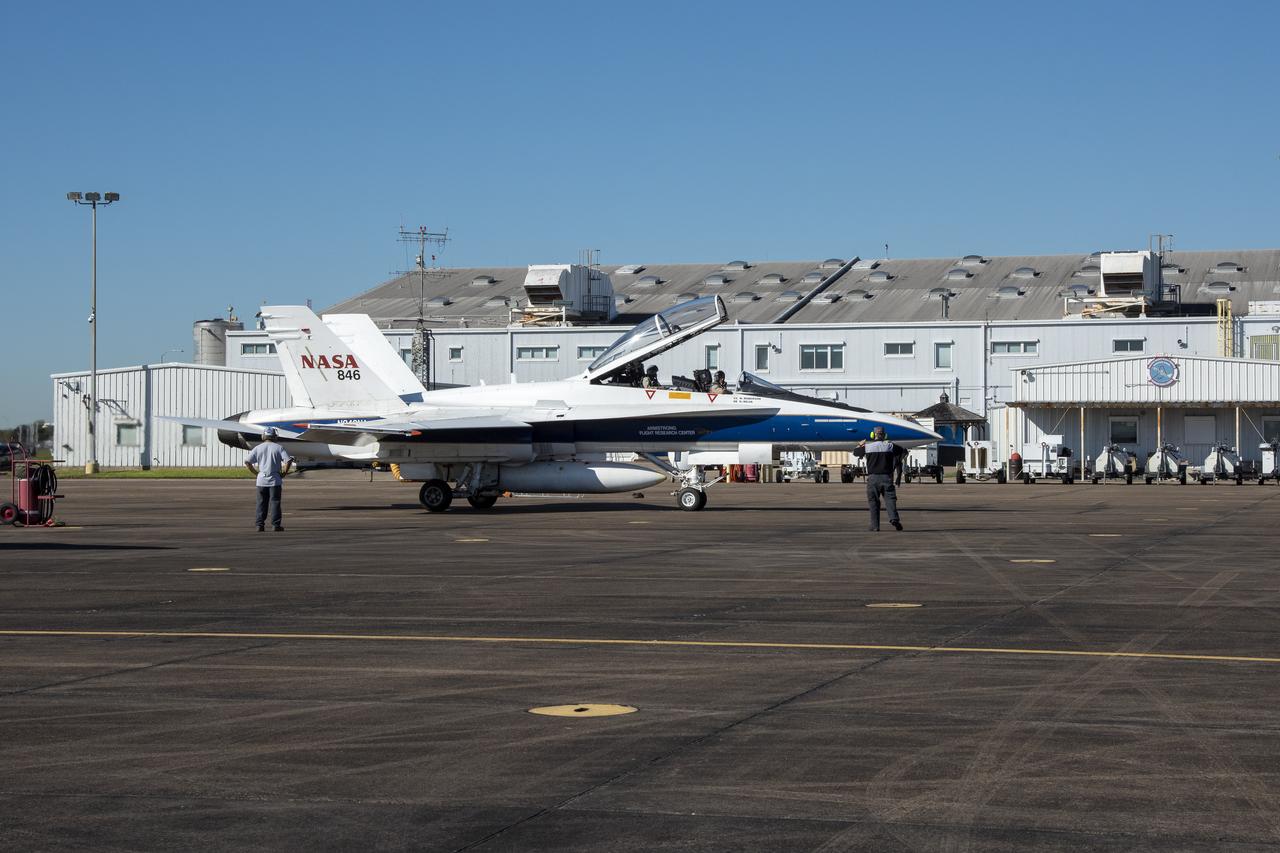 NASA test pilots Jim “Clue” Less and Wayne “Ringo” Ringelberg step to the F/A-18 research aircraft at Ellington Field and conduct pre-flight safety checks on the aircraft prior to a supersonic research flight for the QSF18 series.