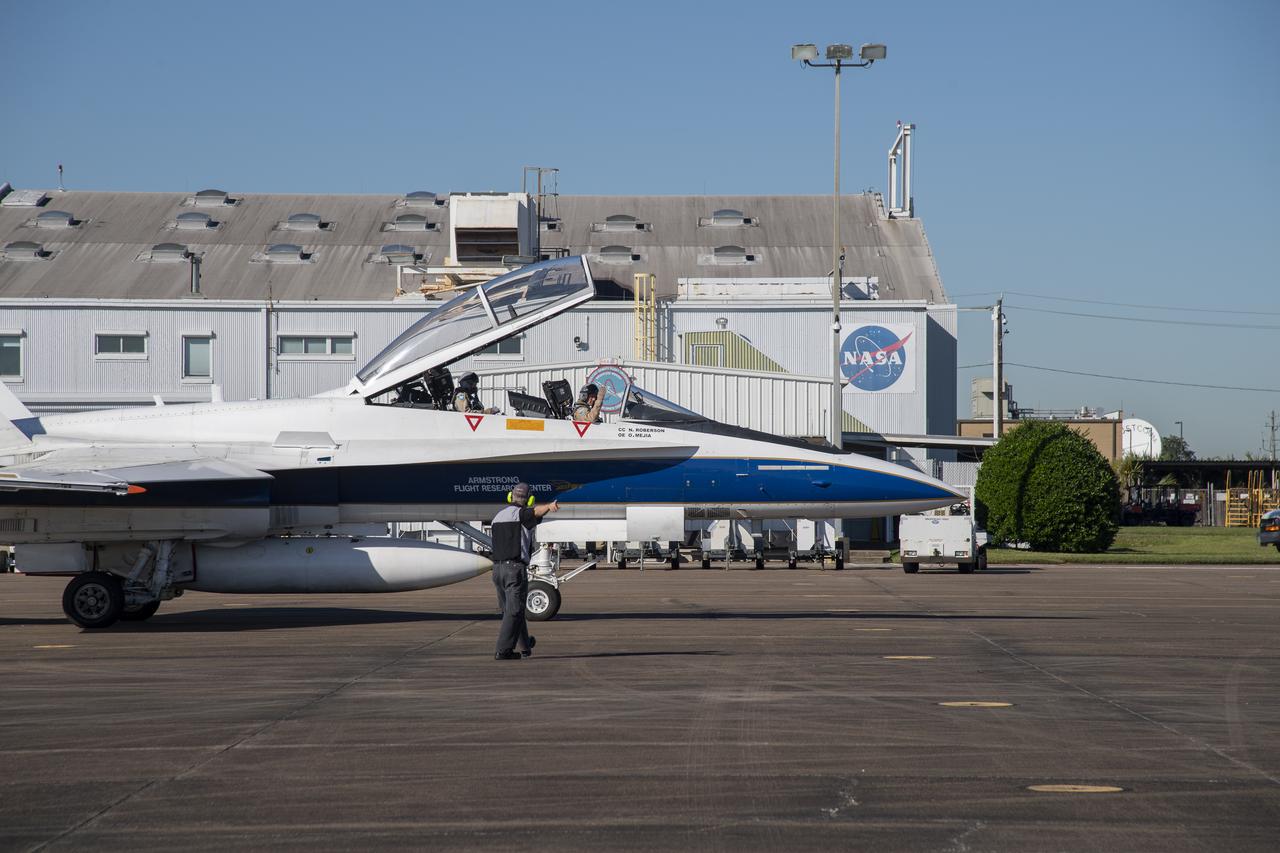 NASA test pilots Jim "Clue" Less and Wayne "Ringo" Ringelberg step to the F/A-18 research aircraft at Ellington Field and conduct pre-flight safety checks on the aircraft prior to a supersonic research flight for the QSF18 series.