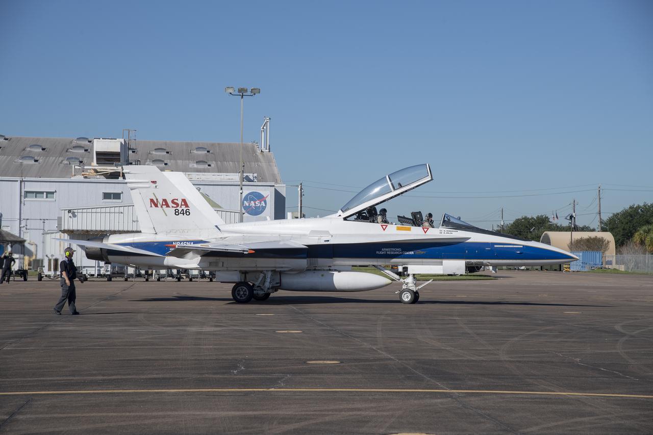 NASA test pilots Jim "Clue" Less and Wayne "Ringo" Ringelberg step to the F/A-18 research aircraft at Ellington Field and conduct pre-flight safety checks on the aircraft prior to a supersonic research flight for the QSF18 series.