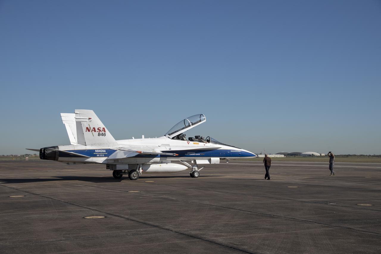 NASA test pilots Jim “Clue” Less and Wayne “Ringo” Ringelberg step to the F/A-18 research aircraft at Ellington Field and conduct pre-flight safety checks on the aircraft prior to a supersonic research flight for the QSF18 series.