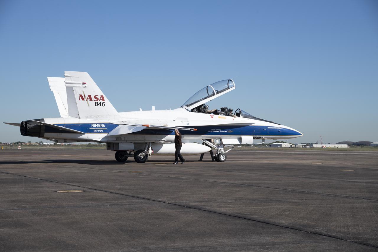 NASA test pilots Jim “Clue” Less and Wayne “Ringo” Ringelberg step to the F/A-18 research aircraft at Ellington Field and conduct pre-flight safety checks on the aircraft prior to a supersonic research flight for the QSF18 series.