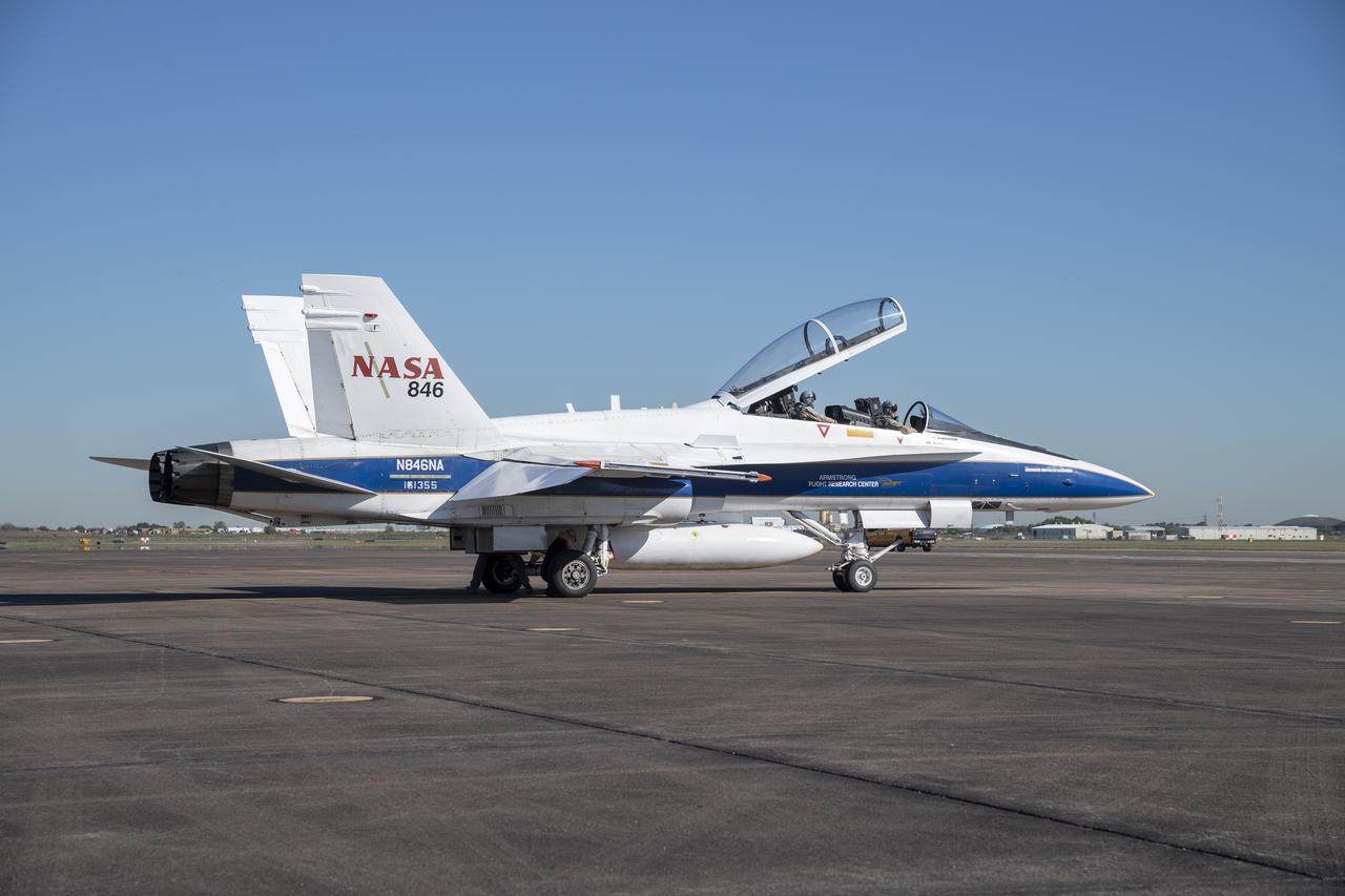 NASA test pilots Jim "Clue" Less and Wayne "Ringo" Ringelberg step to the F/A-18 research aircraft at Ellington Field and conduct pre-flight safety checks on the aircraft prior to a supersonic research flight for the QSF18 series.
