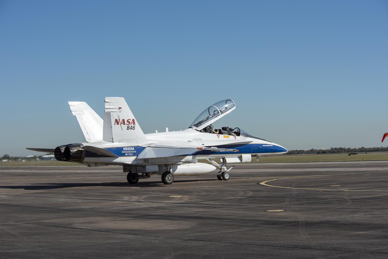 NASA test pilots Jim “Clue” Less and Wayne “Ringo” Ringelberg step to the F/A-18 research aircraft at Ellington Field and conduct pre-flight safety checks on the aircraft prior to a supersonic research flight for the QSF18 series.