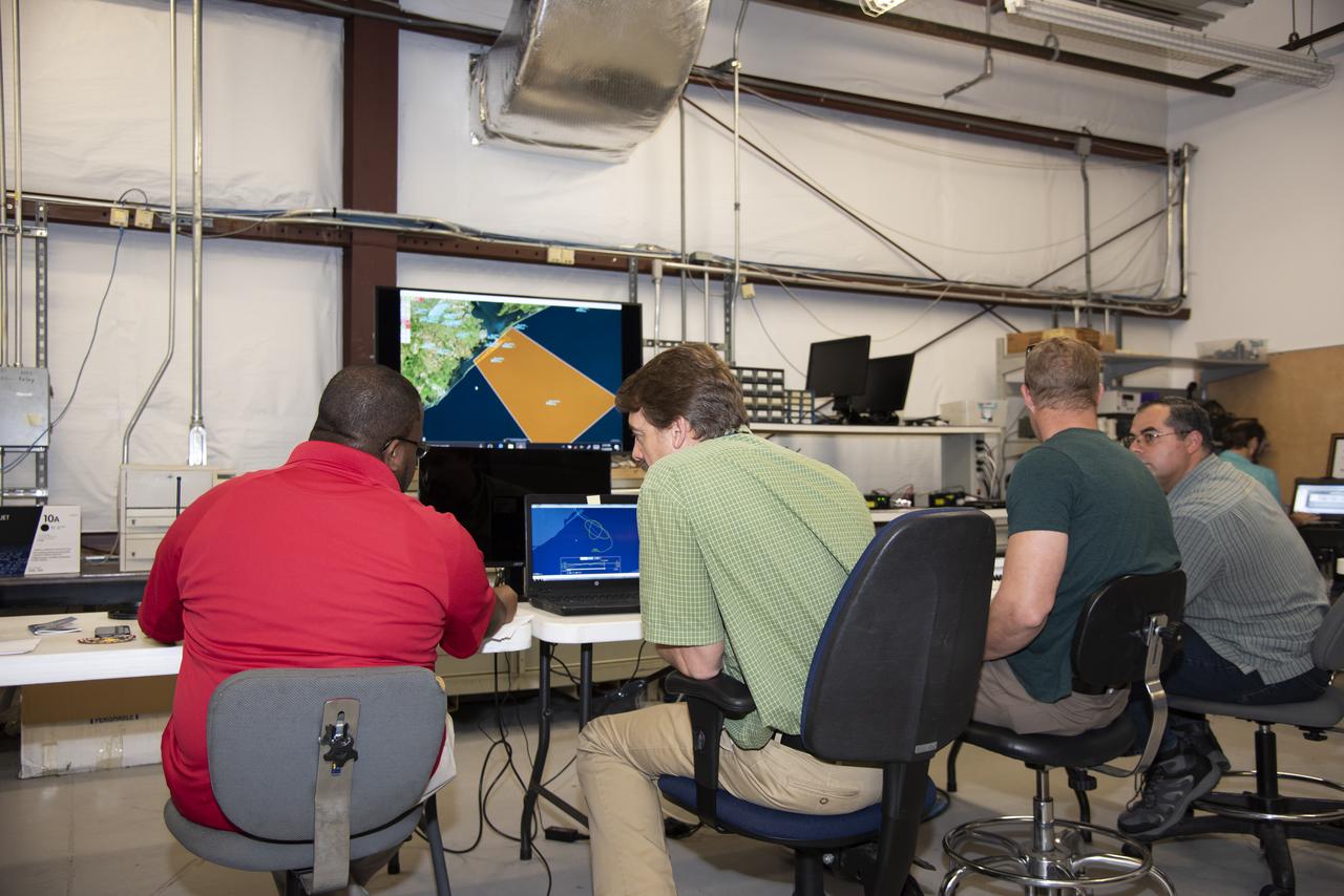 NASA mission controllers, engineers, pilots and communications specialists in the mission control room monitor the supersonic research flight off the coast of Galveston, as part of the QSF18 flight series. The flight operations crew tracks the status of the flights, maintains communications with the aircraft, communicates with U.S. Coast Guard, and coordinates community feedback data.