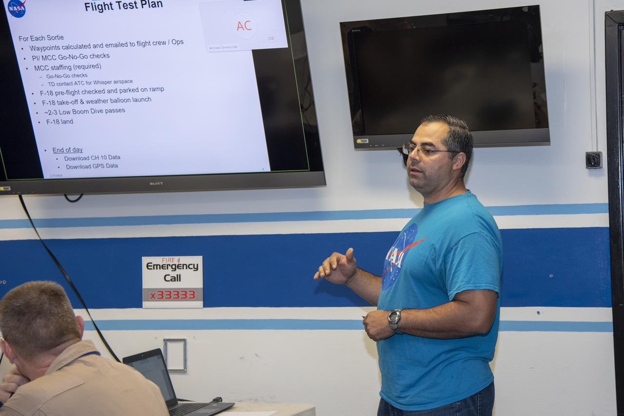 The flight operations crew for NASA’s QSF18 flight series debriefs following a flight with the F/A-18 research aircraft. The flight included a quiet supersonic dive maneuver at high altitudes off the coast to produce a sonic boom out over the ocean, with the intention of producing quieter “thumps” on land.
