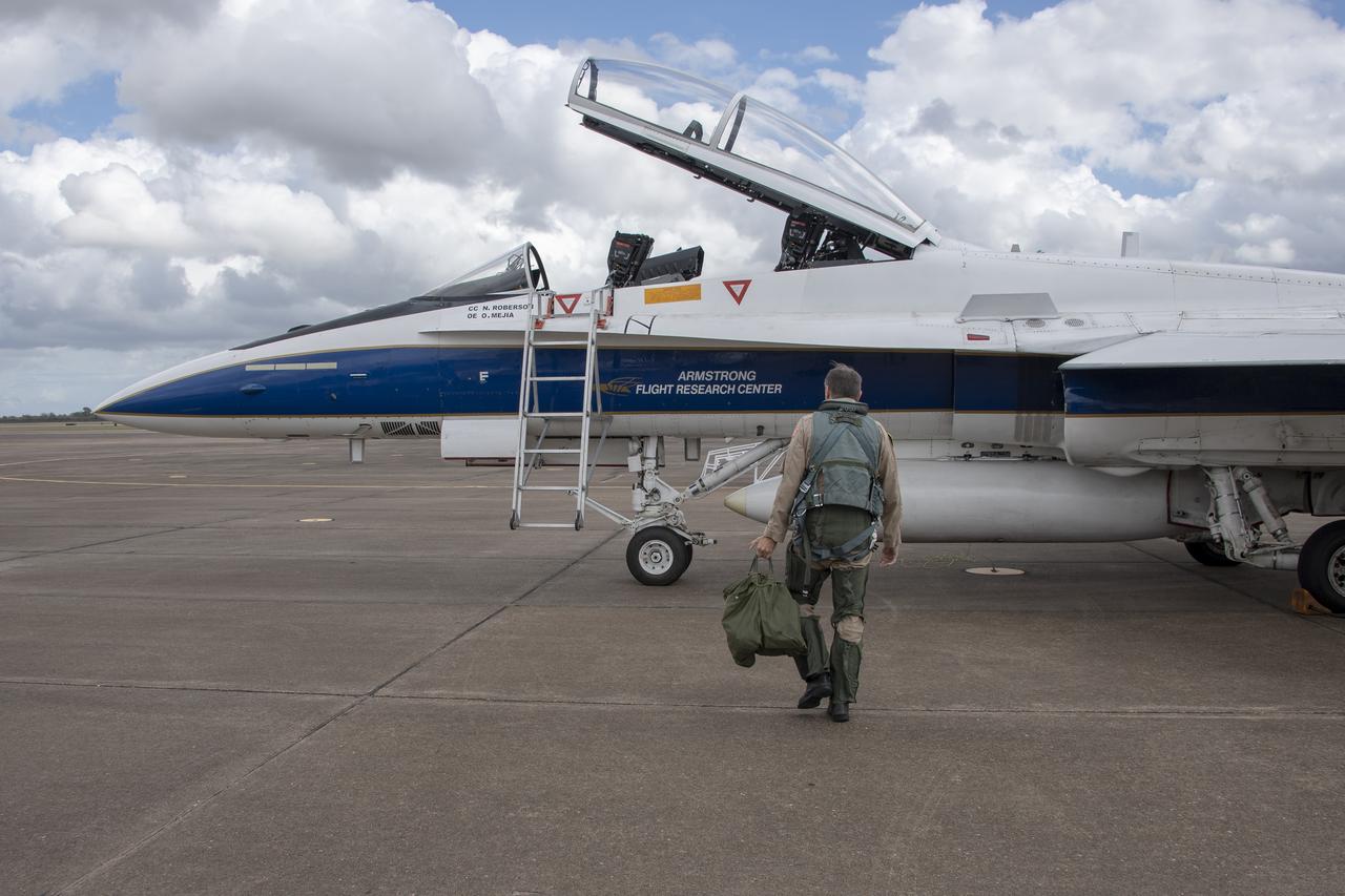 NASA test pilot Wayne "Ringo" Ringelberg and photographer Carla Thomas prepare to take off for a supersonic research flight in support of the QSF18 campaign off the coast of Texas. NASA photographers and videographers take part in operations to support mission documentation.
