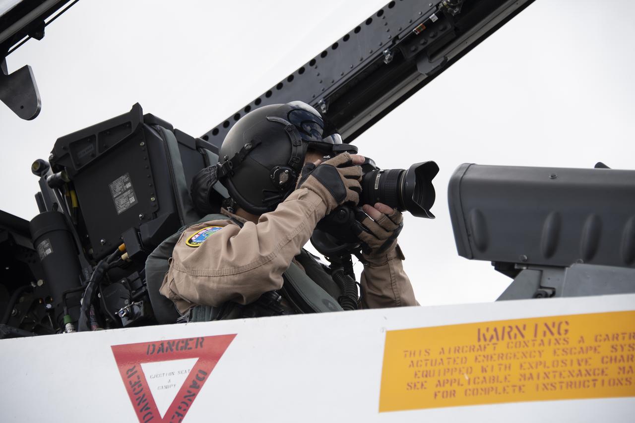 NASA test pilot Wayne “Ringo” Ringelberg and photographer Carla Thomas prepare to take off for a supersonic research flight in support of the QSF18 campaign off the coast of Texas. NASA photographers and videographers take part in operations to support mission documentation.
