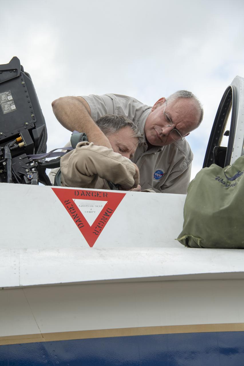 NASA test pilot Wayne “Ringo” Ringelberg and photographer Carla Thomas prepare to take off for a supersonic research flight in support of the QSF18 campaign off the coast of Texas. NASA photographers and videographers take part in operations to support mission documentation.