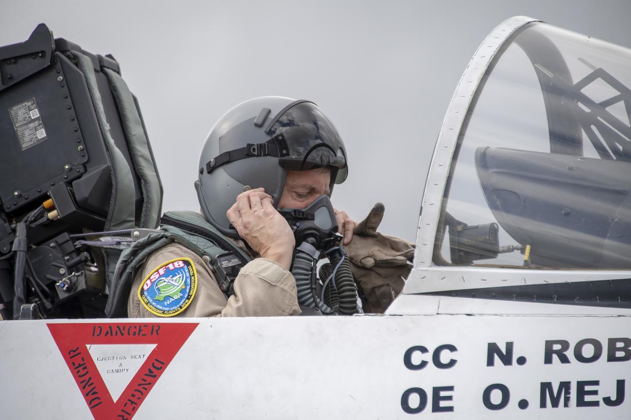 NASA test pilot Wayne “Ringo” Ringelberg and photographer Carla Thomas prepare to take off for a supersonic research flight in support of the QSF18 campaign off the coast of Texas. NASA photographers and videographers take part in operations to support mission documentation.