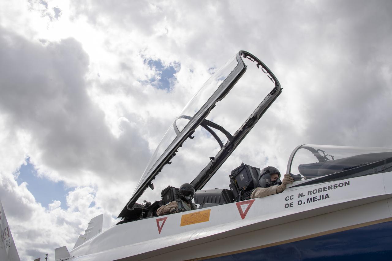 NASA test pilot Wayne “Ringo” Ringelberg and photographer Carla Thomas prepare to take off for a supersonic research flight in support of the QSF18 campaign off the coast of Texas. NASA photographers and videographers take part in operations to support mission documentation.