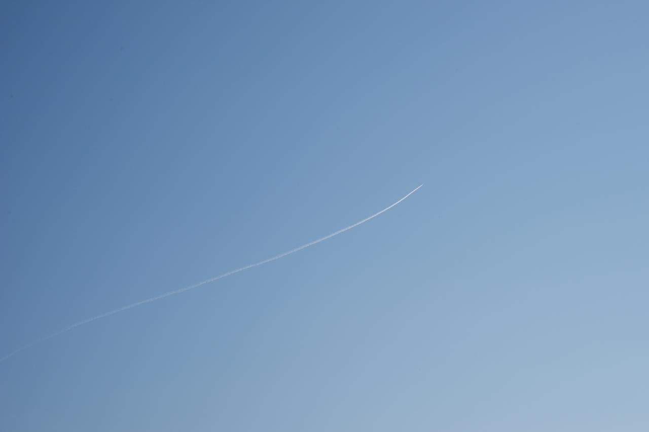 A contrail of the NASA F/A-18 research aircraft is seen off the coast of Galveston, performing the quiet supersonic dive maneuver in support of the QSF18 flight series.