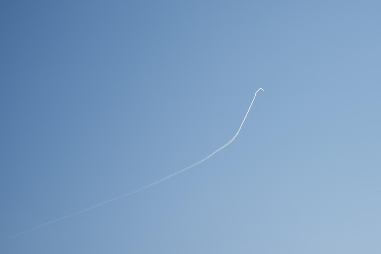 A contrail of the NASA F/A-18 research aircraft is seen off the coast of Galveston, performing the quiet supersonic dive maneuver in support of the QSF18 flight series.