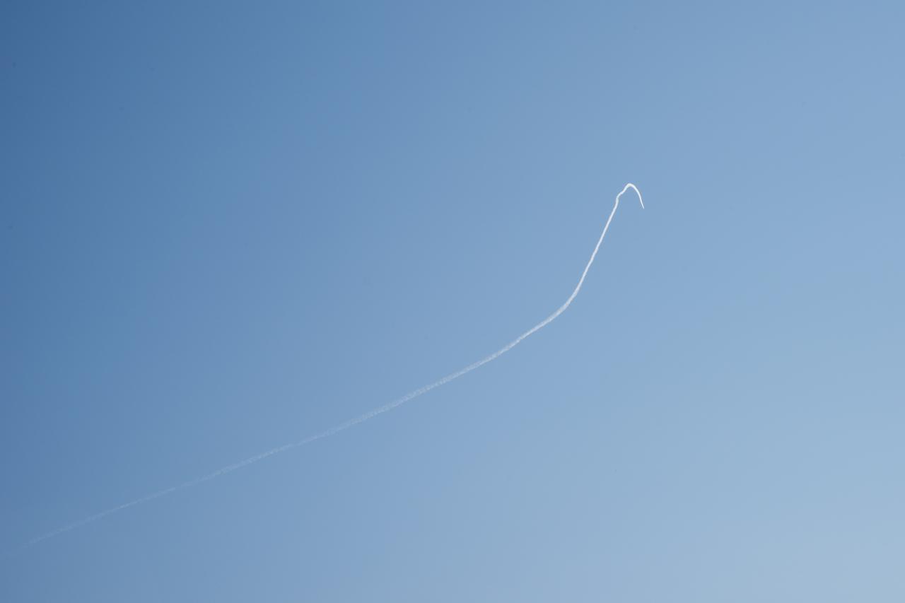 A contrail of the NASA F/A-18 research aircraft is seen off the coast of Galveston, performing the quiet supersonic dive maneuver in support of the QSF18 flight series.