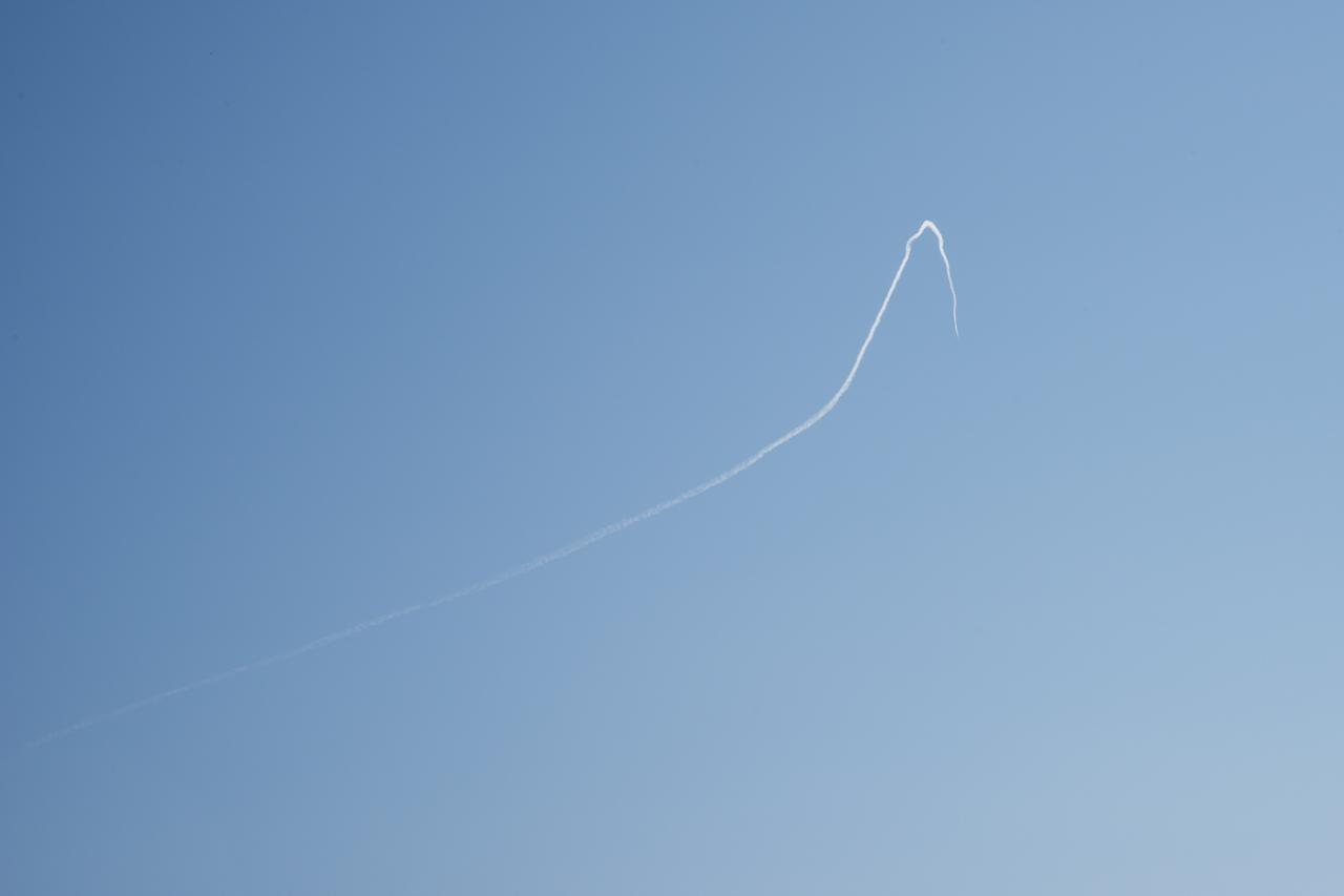 A contrail of the NASA F/A-18 research aircraft is seen off the coast of Galveston, performing the quiet supersonic dive maneuver in support of the QSF18 flight series.