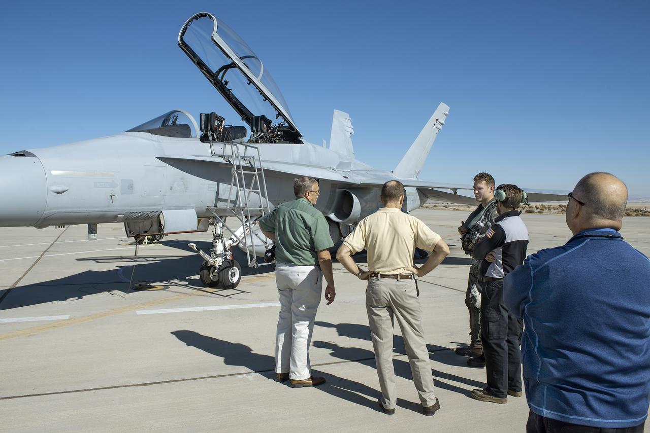 Lt. Cmdr. Mike Shelton delivers a F/A/-18B Hornet to NASA’s Armstrong Flight Research Center in California. Shelton, center, was met by Armstrong’s Tom Grindle, from left, Ted Williams, Gary Gano and Brian Fox.