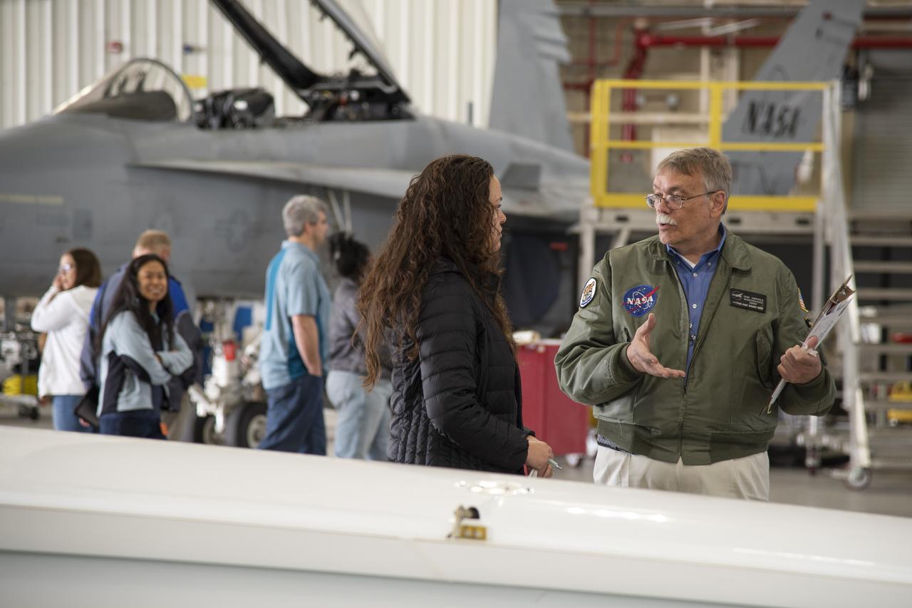 NASA Armstrong’s Chief of Maintenance, Tom Grindle, leads a tour inside the hangar with a group of teachers. 