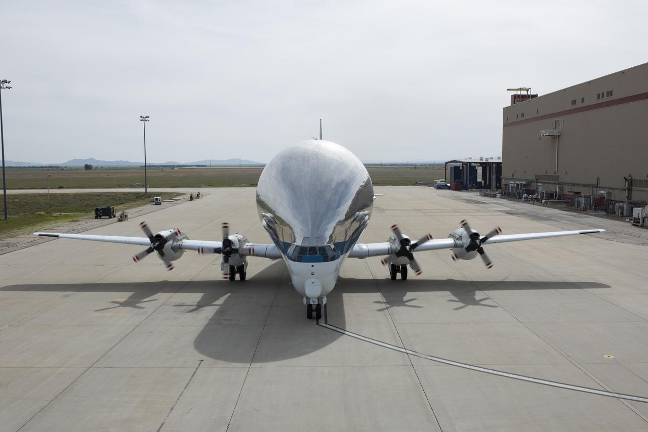 Front view of NASA’s Super Guppy cargo transport aircraft as it taxis in at NASA’s Armstrong Flight Research Center Building 703 ramp.